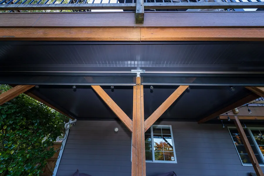 Underdeck roofing installed beneath a raised deck